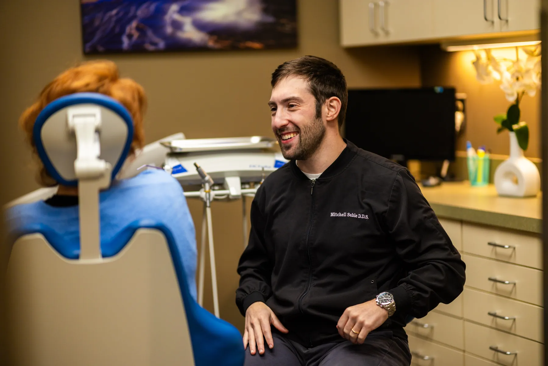 Dr. Mitchell Sable talking with a patient in a treatment room