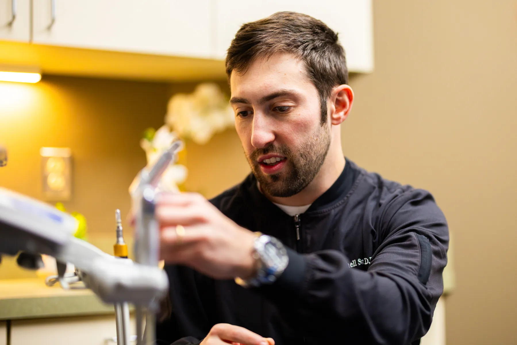 Dr. Mitchell Sable preparing dental materials in the treatment room